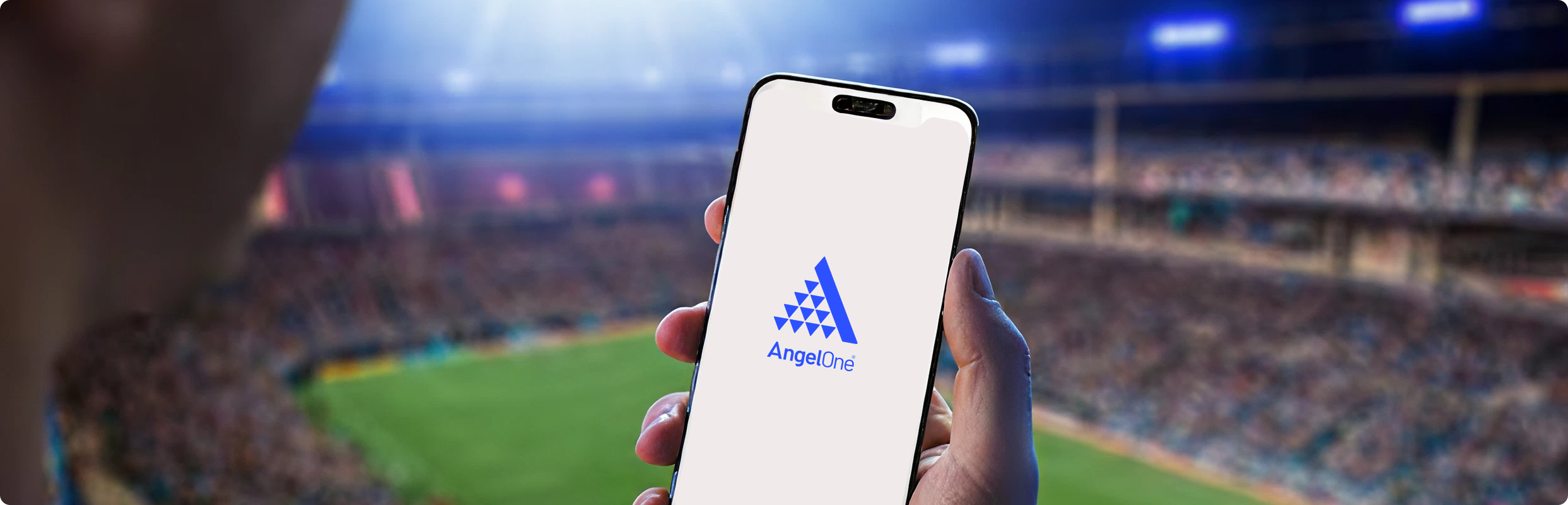 Angel One app in hand at the stadium - smart investing